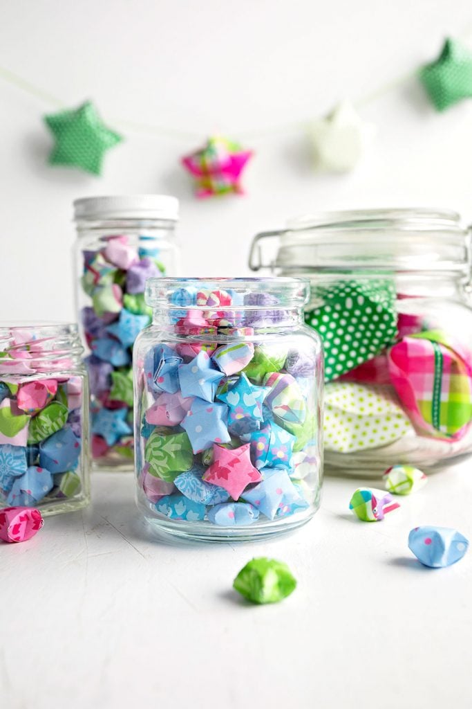 mason jars full of lucky paper stars 