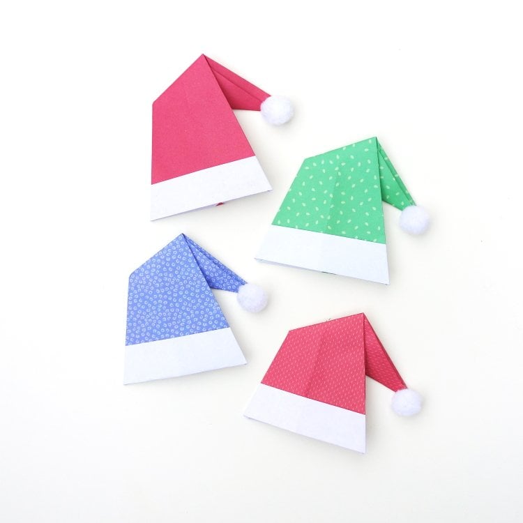 four origami santa hats in festive colors