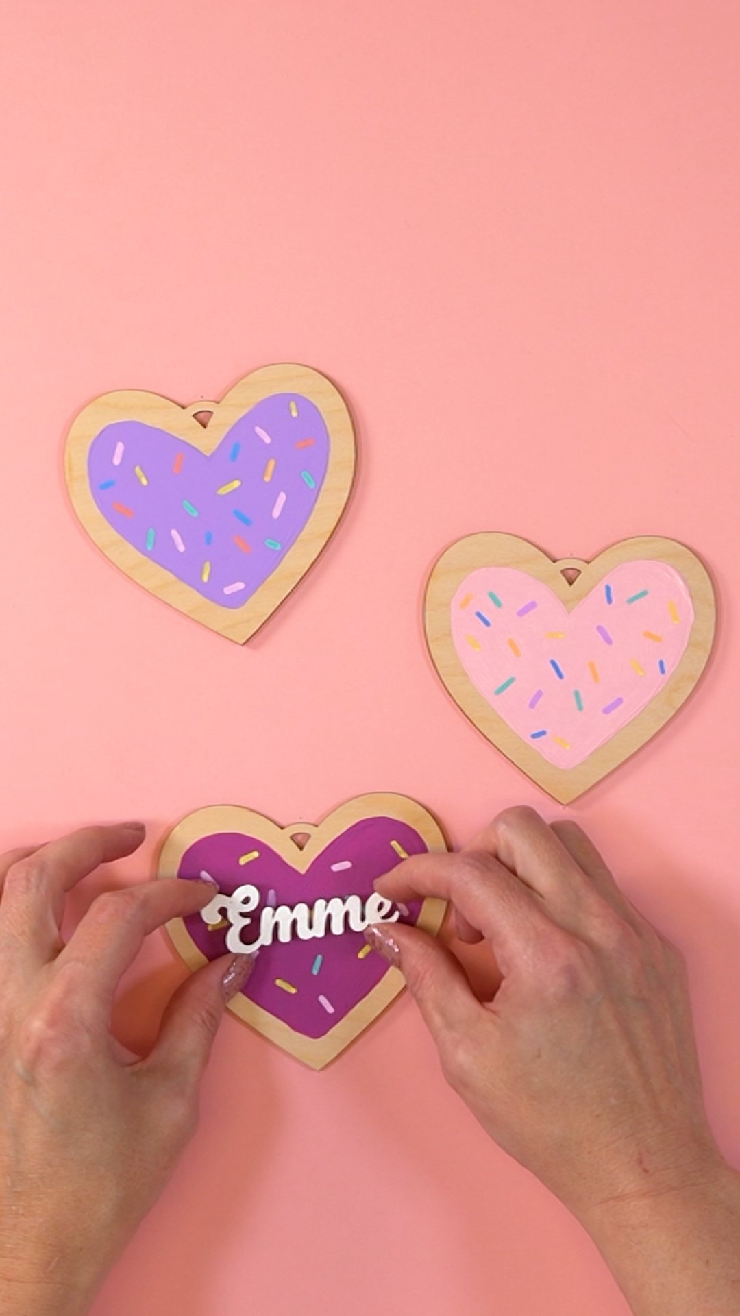 Hands assembling a Valentine heart "cookie" ornament