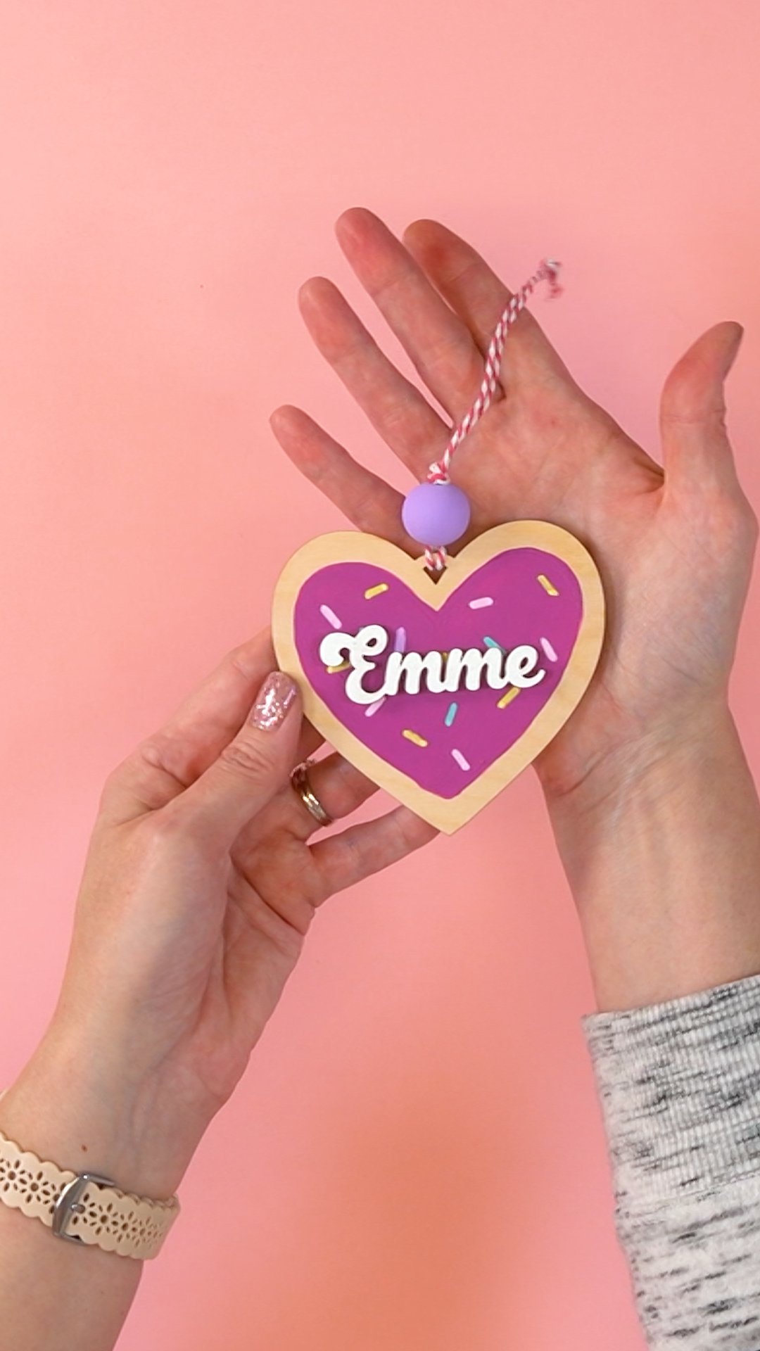 Hand displaying finished Valentine heart "cookie" ornament