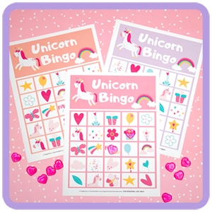 3 printable Unicorn Bingo Game cards on pink background