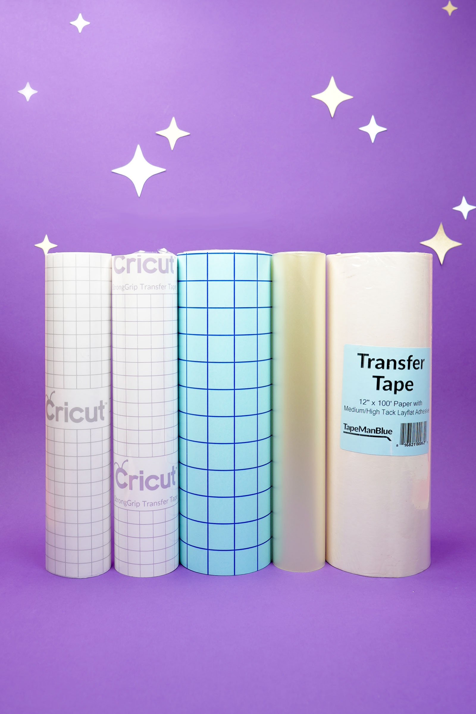 Five different types of vinyl transfer tape on rolls on a purple background