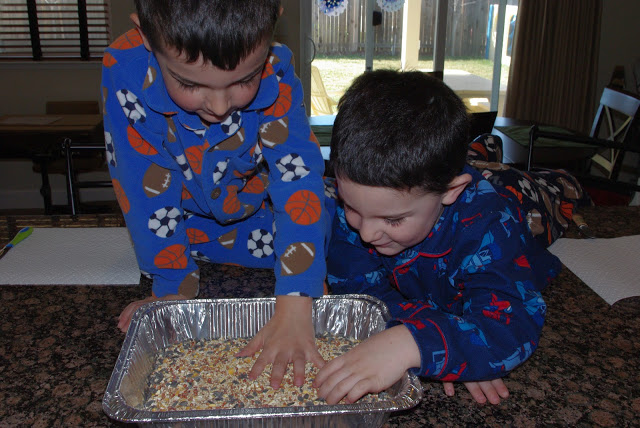 kids prepping bird feeder