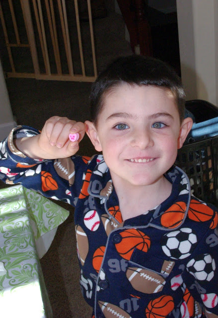 child holding up conversation heart 