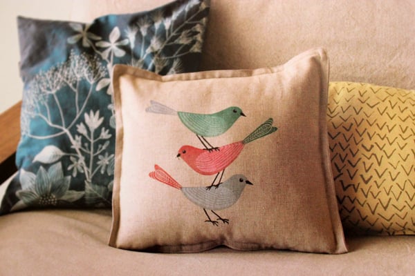 pillow stamped with images of birds
