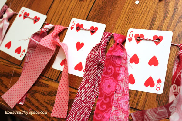 stringing heart card garland with cut pink ribbons