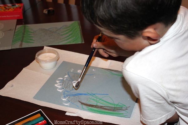 children using faux snow to paint with 