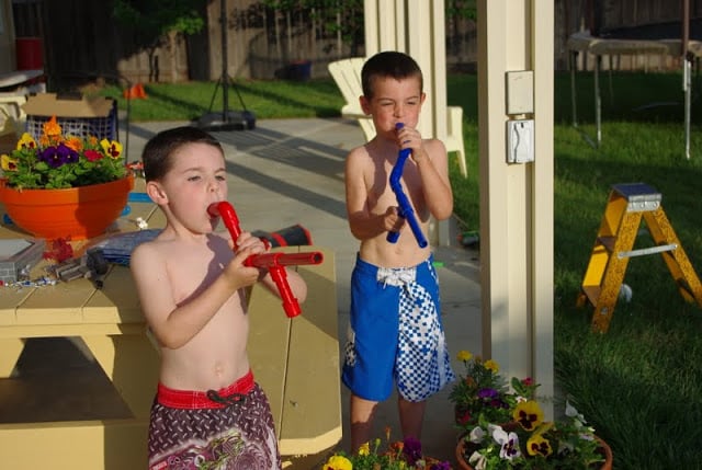 boys blowing out marshmallows from their shooters