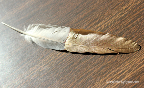 feather tip dipped in gold