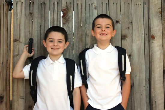 adorable young boys posing for school picture outside 