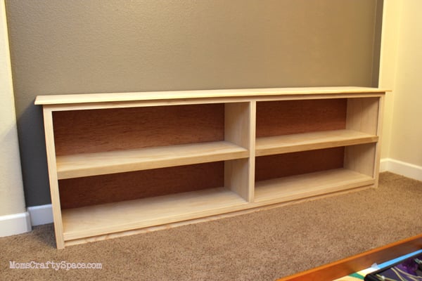 unpainted book shelf in room