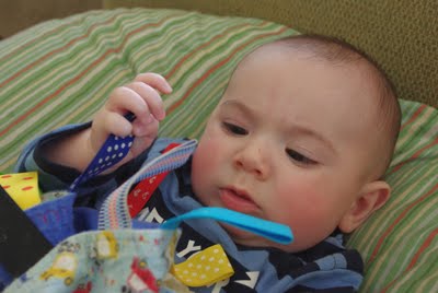 small baby enjoying baby blanket