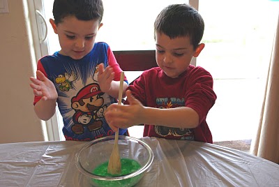 kids mixing up homemade slime recipe