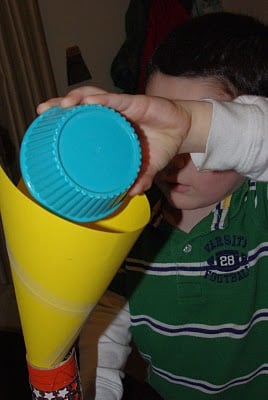 child pouring items into rainsticks