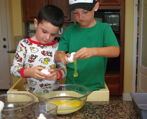 kids cracking eggs into bowls