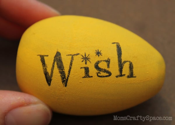 wish sticker added to bright and colorful yellow easter egg