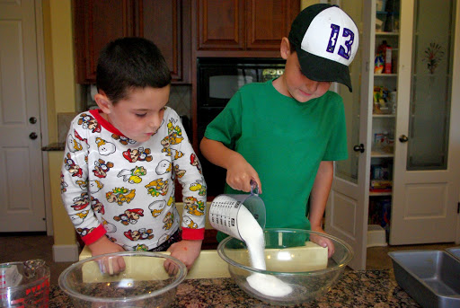 kids cooking banana bread in two large bowls