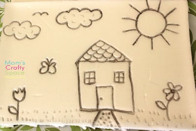 image drawn into styrofoam of house and sunshine 