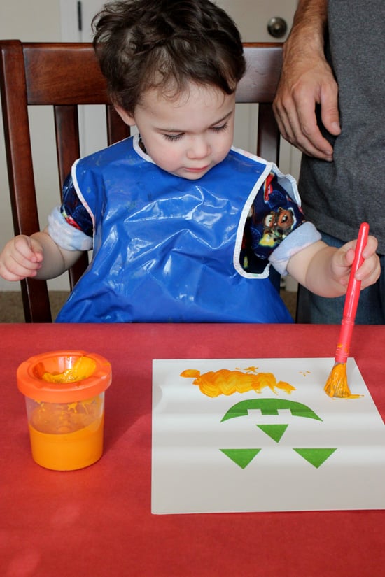 small boy enjoying halloween painting activity for preschooler