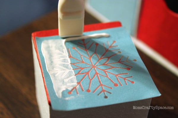 scraping paint over silk screen snowflake pattern
