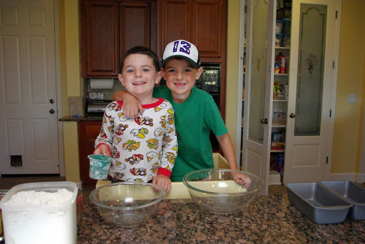 two brothers hugging with banana bread supplies 