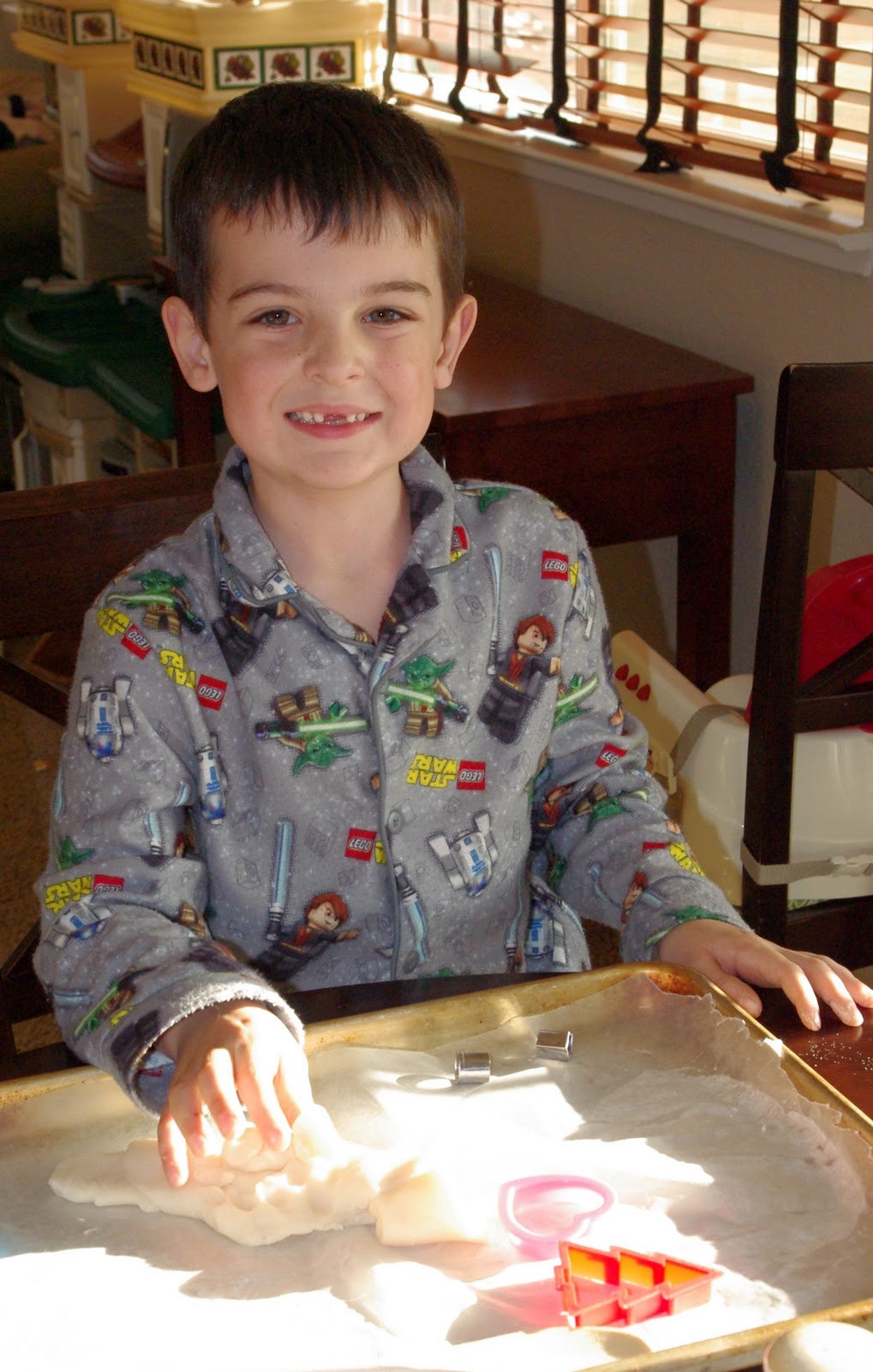 child rolling out glittery snow playdough