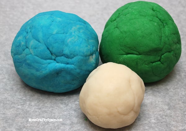 blue white and green balls of playdough 