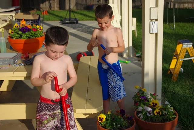 kids loading marshmallow shooters outside for fun summer kids activity