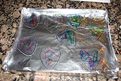 kid colored guitar picks on foil 