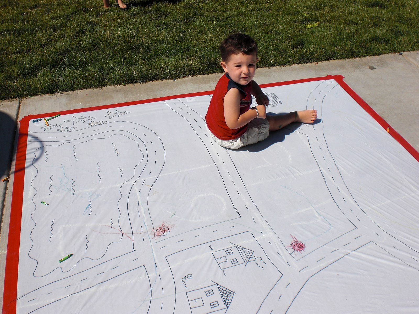 child playing outdoors on diy shower curtain playmat 