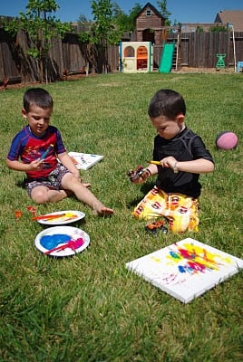 boys outside enjoying easy kids painting activities 