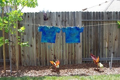 blue batik shirts drying on clothesline