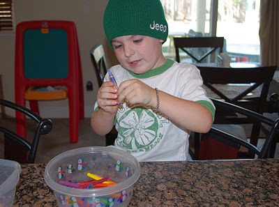 child unwrapping color crayons