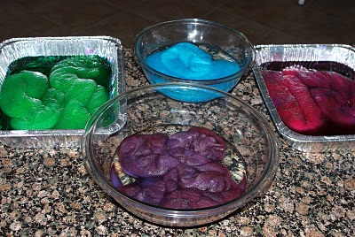 colorful wool being dyed in separate containers 