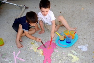 kids painting outside with diy chalk paint