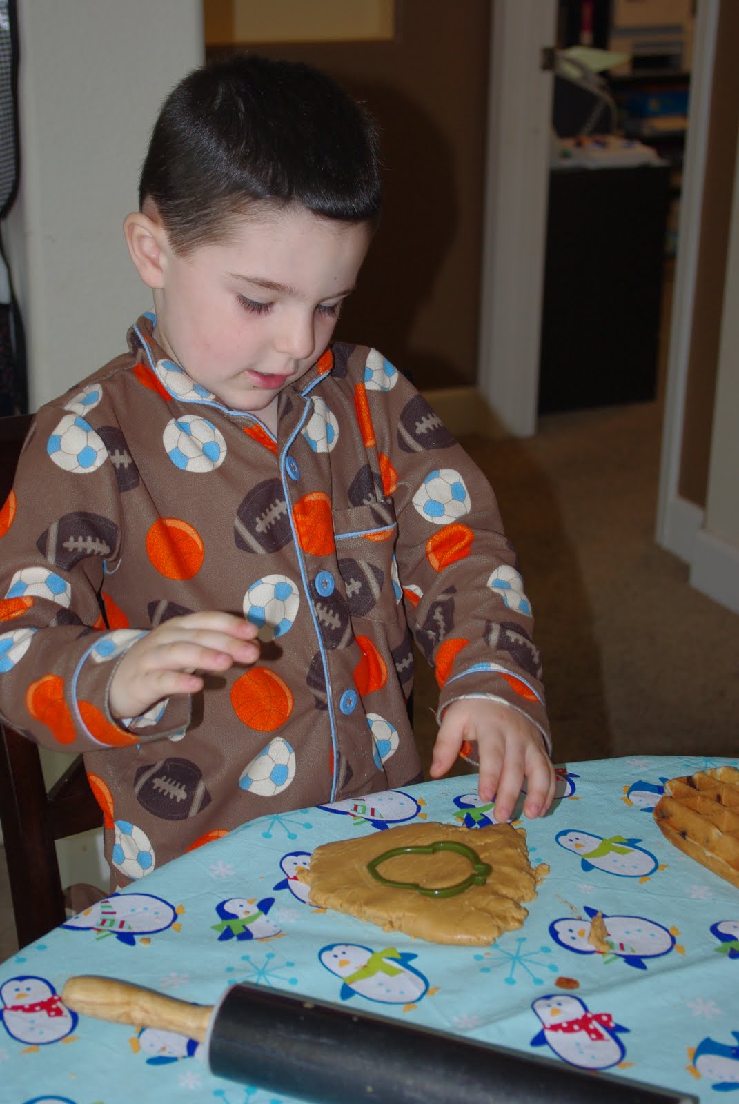 child playing with homemade playdough at table