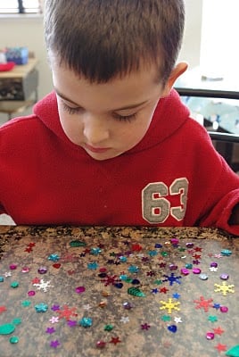child picking embellishments for design