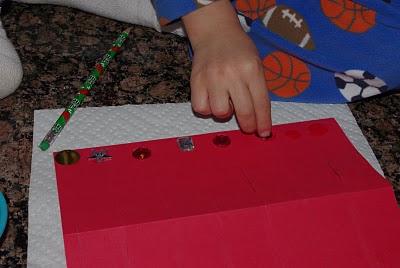 child adding decoration to chinese lantern craft