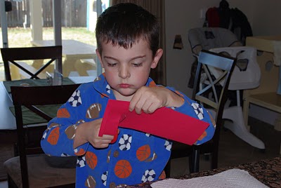 kids cutting paper for homemade lanterns