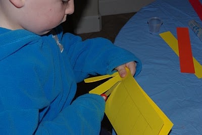 kids cutting paper for lantern